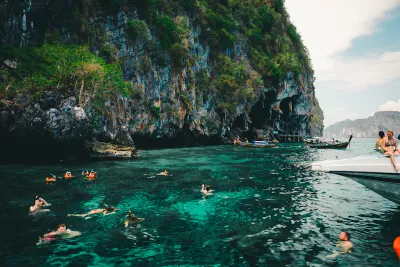Group of tourists snorkeling in crystal clear water
